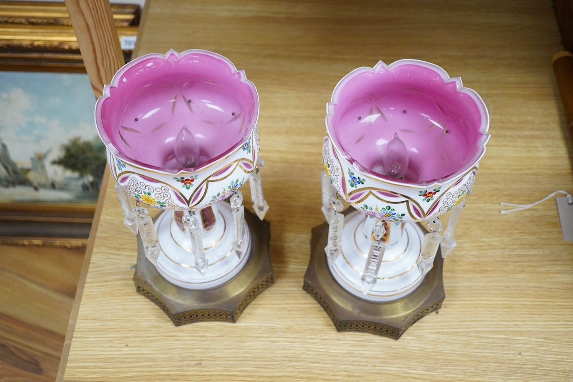 A pair of Bohemian/Czech overlaid glass table lustres raised on octagonal pierced metal bases, 31cm high